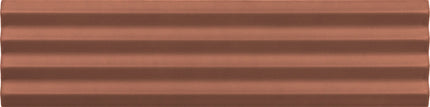 A close-up of a copper-colored textured material with horizontal ridges, filling the entire frame.