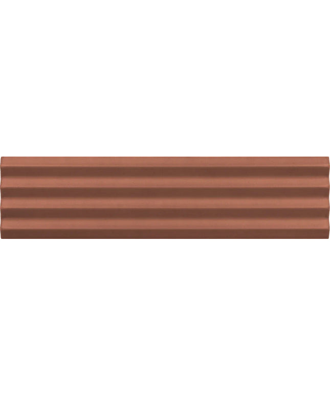 A close-up of a copper-colored textured material with horizontal ridges, filling the entire frame.