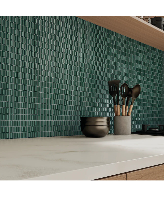 Kitchen counter with green tiled backsplash and utensil holder.
