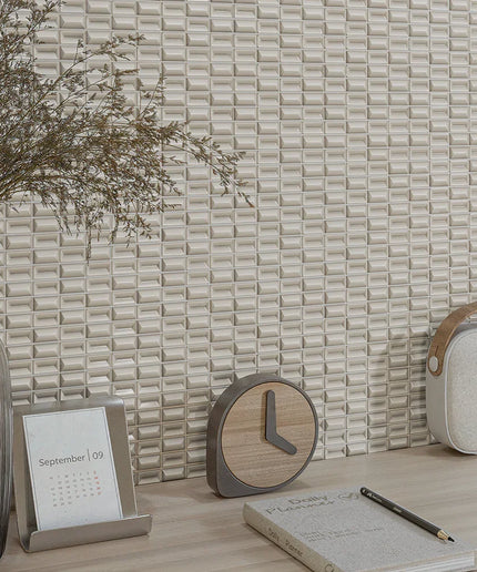 Decorative items including a clock, calendar, notebook, and pen on a textured wall background.