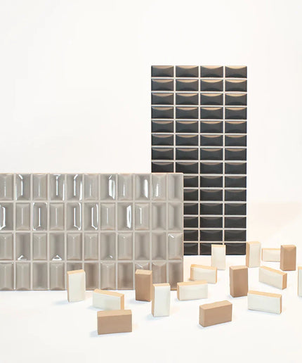 Collection of glass and ceramic tiles in various patterns and sizes on a white background
