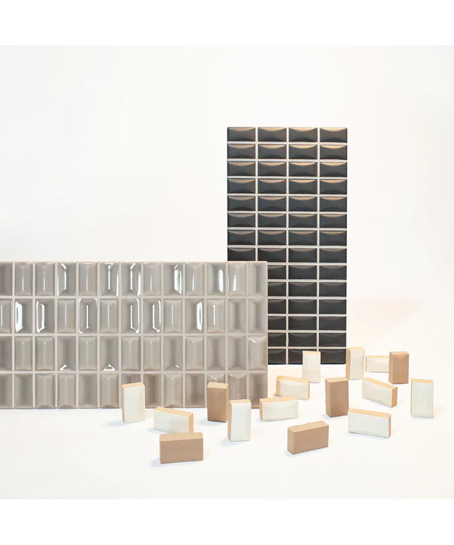 Collection of glass and ceramic tiles in various patterns and sizes on a white background