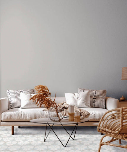 Modern living room with patterned hexagon tile floor, neutral sofa, and natural decor.