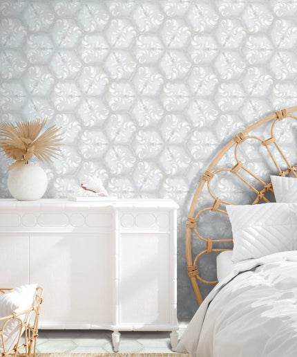 Hexagon patterned tile wall and floor in a modern white bedroom with rattan and decor accents