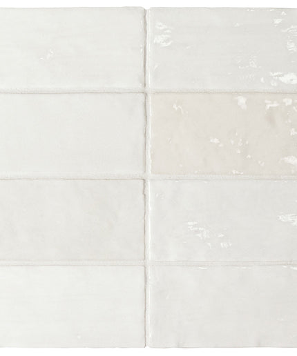 White tiles with subtle patterns on a white background