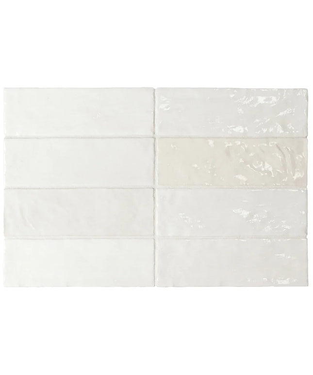 White tiles with subtle patterns on a white background