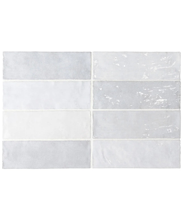 Six rectangular ceramic subway tiles arranged in a 3-by-2 grid, featuring various finishes including matte, glossy, and textured in light gray and white tones.