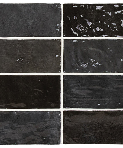 Nine black rectangular tiles with varying textures and finishes.