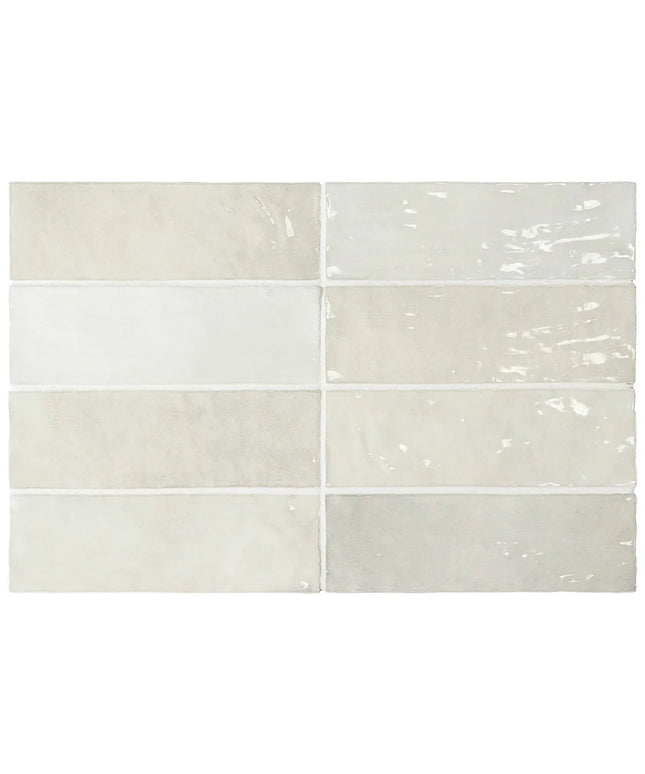 Six rectangular ceramic subway tiles arranged in a 3-by-2 grid, showcasing different finishes and colors including glossy, matte, and textured surfaces in off-white, beige, and light gray tones.