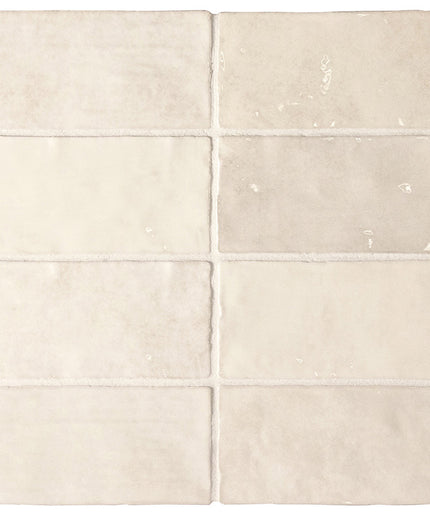 Set of six beige ceramic tiles with subtle patterns on a white background