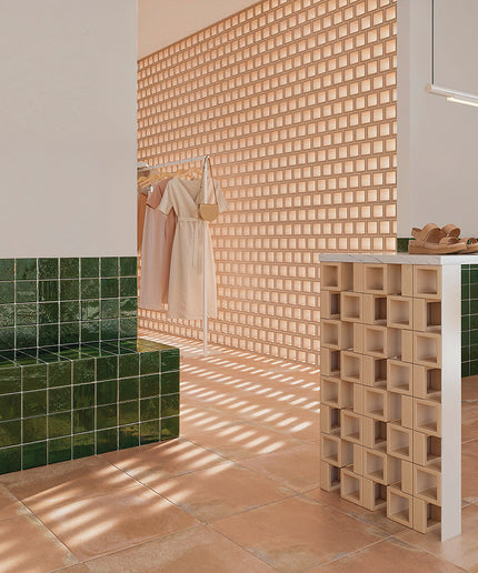 Modern bathroom with green tiles, wooden wall, and white fixtures