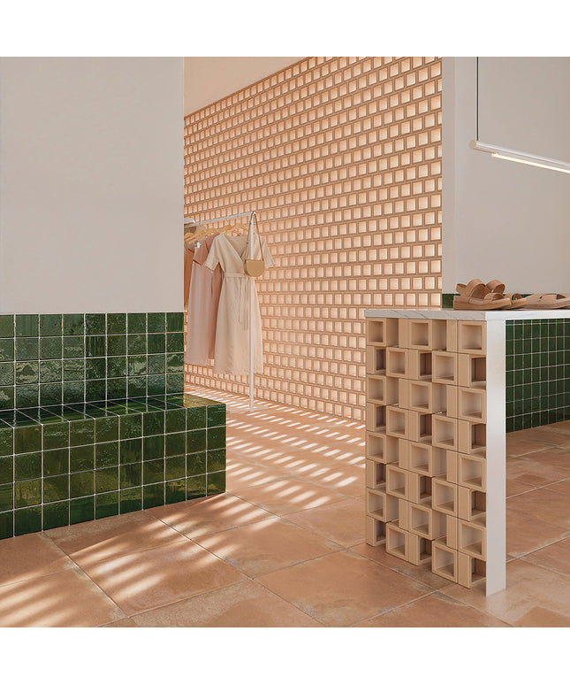 Modern bathroom with green tiles, wooden wall, and white fixtures