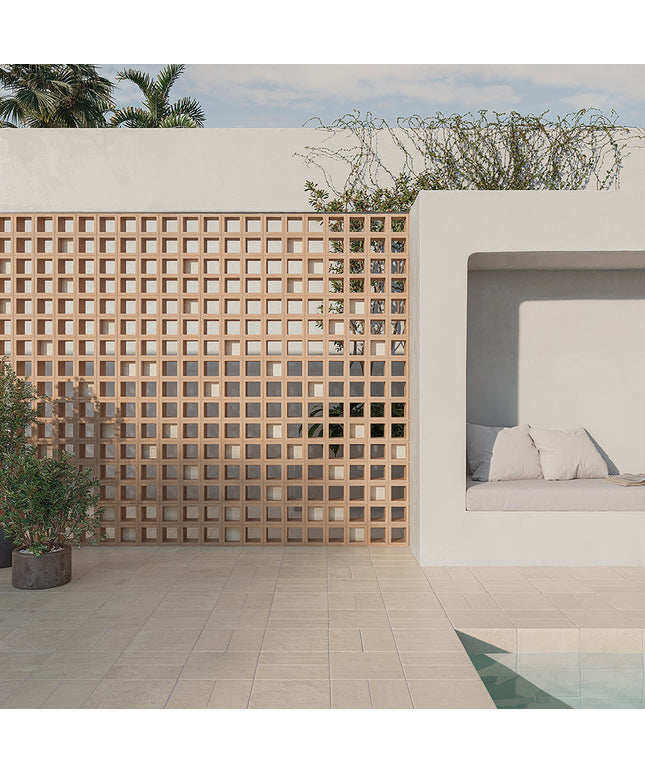 Modern outdoor setting with a geometric wooden screen, white sofa, and pool.