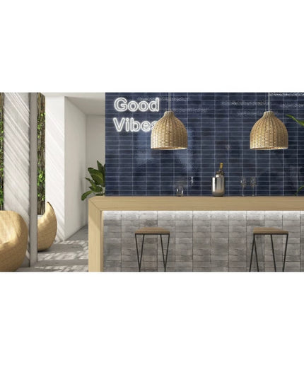 Modern kitchen bar with navy blue tile backsplash, wicker pendant lights, and bar stools