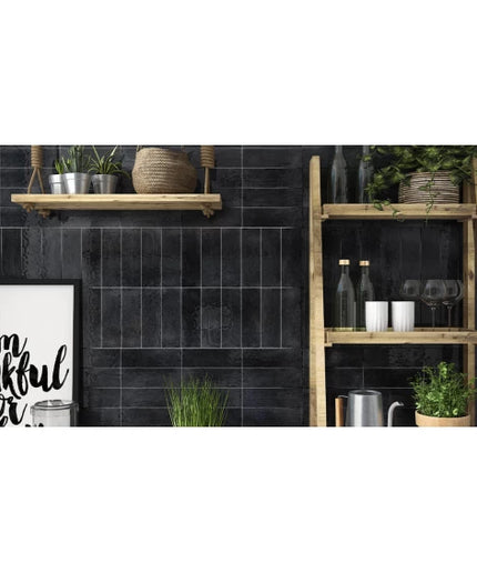 Charcoal subway tile kitchen backsplash with wood shelves and green plants