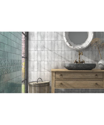 Silver grey vertical wall tiles in a modern bathroom with a wooden vanity and stone sink