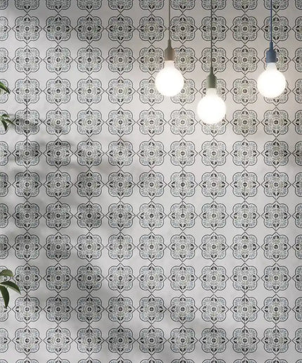 Decorative patterned wall tiles with hanging pendant lights and green indoor plant