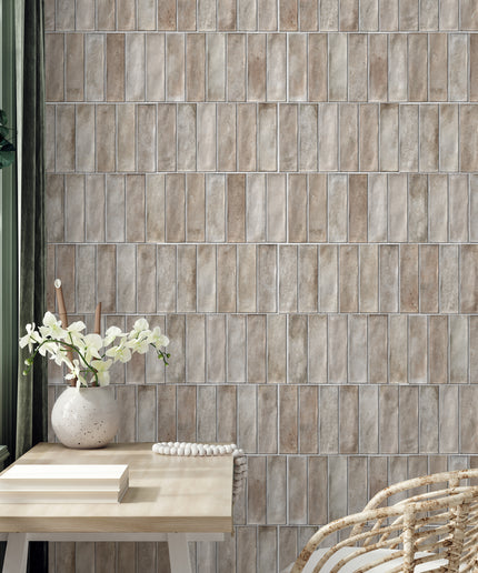Cream rectangular wall tiles in a modern home office with a rattan chair and desk decor