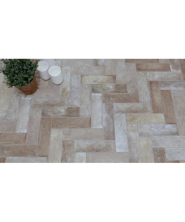 Terracotta herringbone tile flooring with potted plant and white cups decor