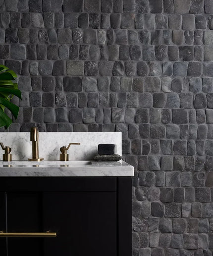 Bathroom vanity with marble countertop and stone wall tiles