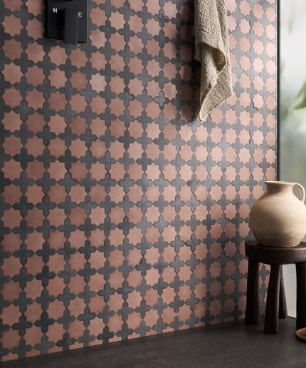 Alpana mara tiles single piece walls. Patterned wall with geometric design, small stool, and decorative items in a room setting.