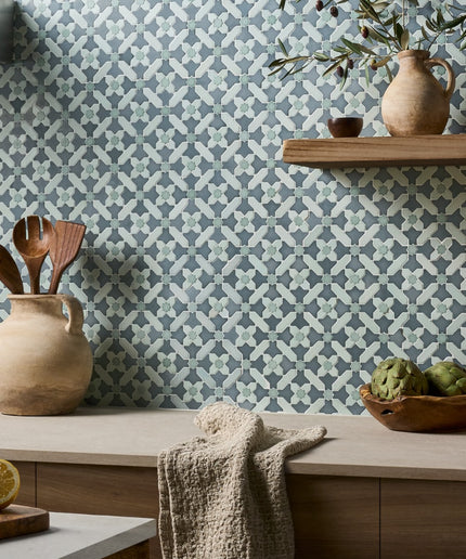 Kitchen with patterned wallpaper, wooden shelves, and decorative items.