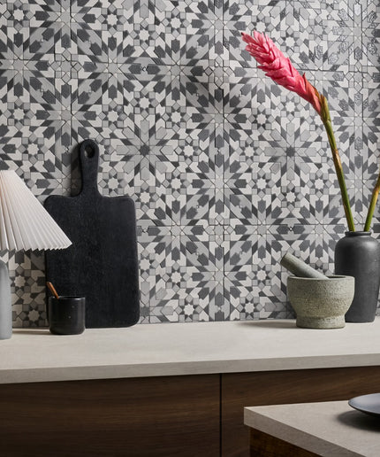 Decorative kitchen scene with patterned tiles, lamps, and vases.