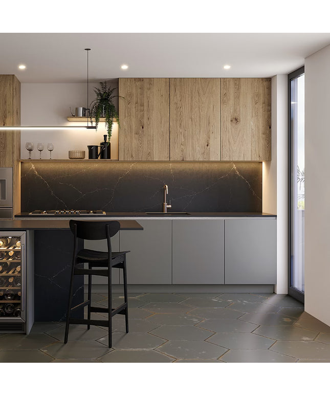 Modern kitchen with wooden cabinets, marble backsplash, and bar area.