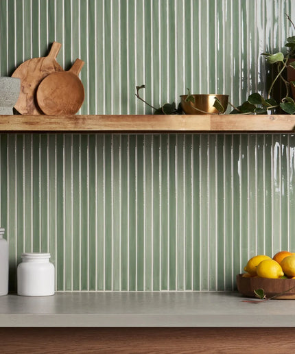 Apple green vertical kitchen backsplash tiles with wood shelf and countertop decor