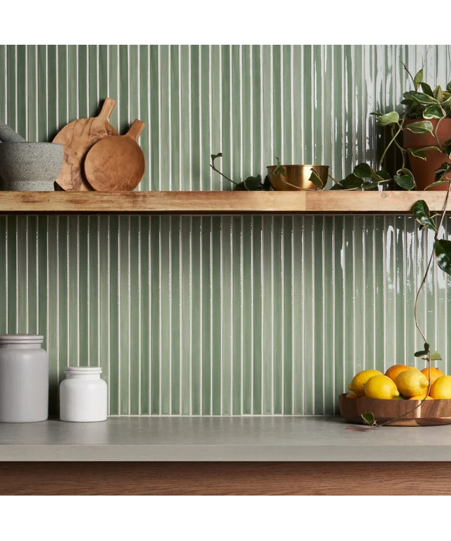 Apple green vertical kitchen backsplash tiles with wood shelf and countertop decor