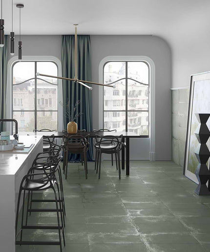 Modern kitchen with island, stools, and large windows.