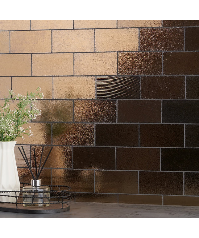 Decorative wall with brown and beige tiles, featuring a vase with flowers and a diffuser.