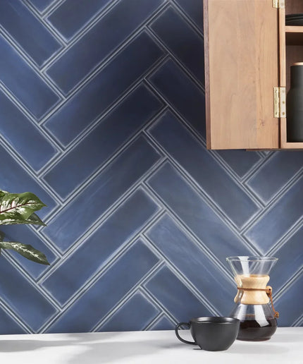 Denim blue matte 4x16 tile backsplash in herringbone pattern kitchen setting