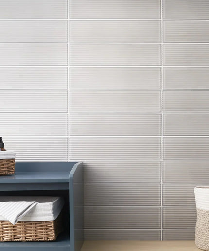Grigio fluted 4x16 wall tiles in a bathroom setting with storage baskets and bottles