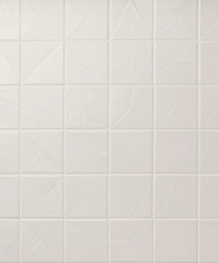 White tiled wall with geometric pattern