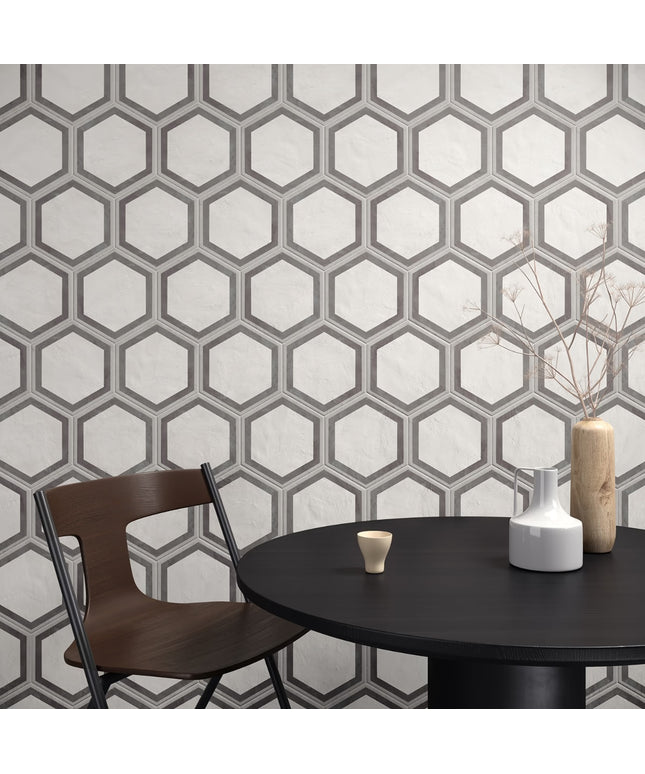Hexagonal patterned wall with a table and chairs in the foreground