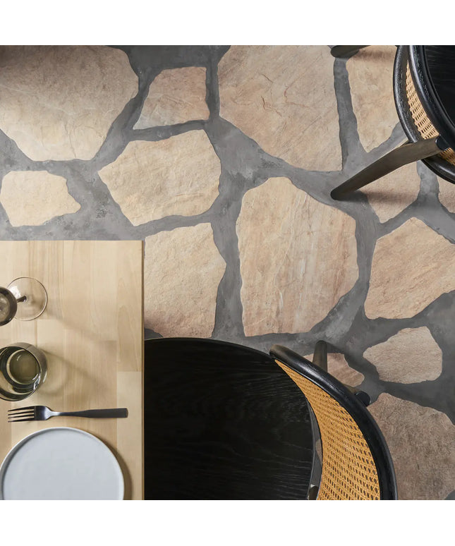 Top-down view of a stone-patterned floor with a table setting and chairs.