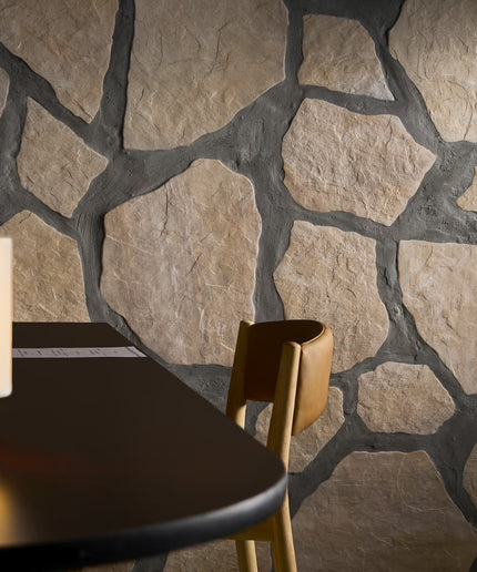 Stone wall with a table and chair in the foreground