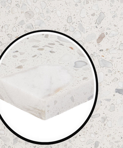 Close-up of a textured stone surface with a circular inset showing a detailed view.