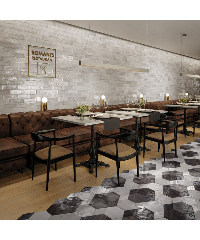 Modern restaurant interior with tables, chairs, and a decorative wall sign.