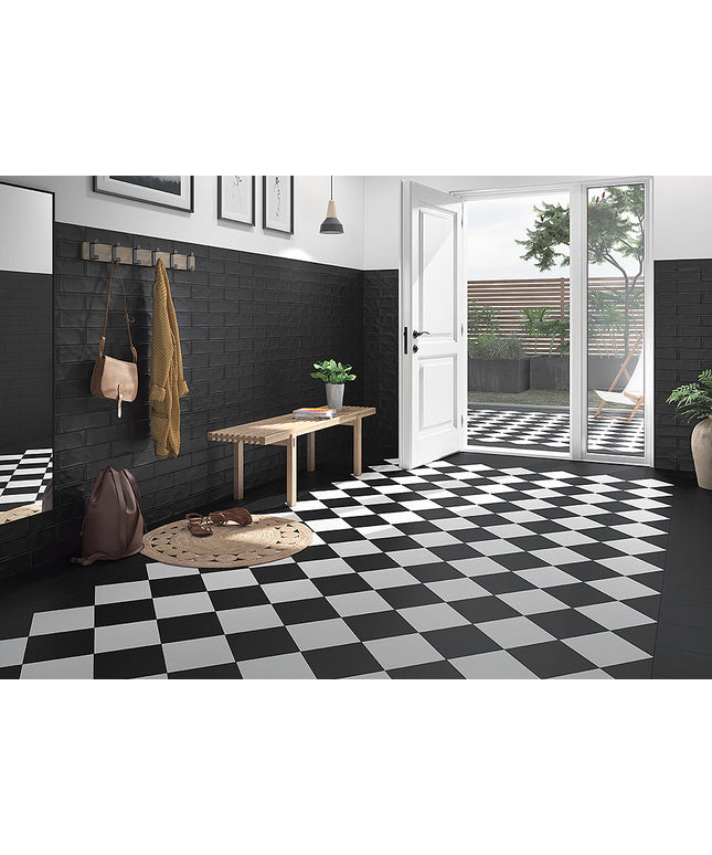 Modern interior with black and white checkered floor, wooden bench, and open door leading to garden.