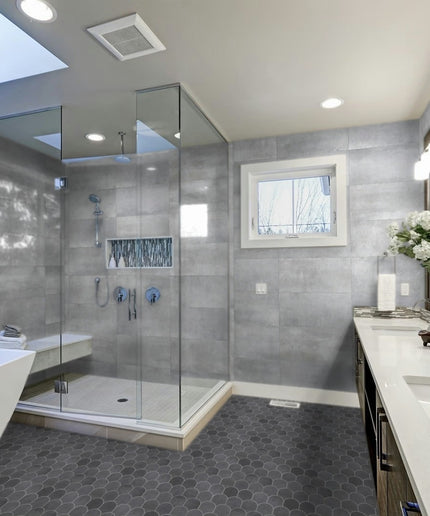 Modern bathroom with glass shower enclosure, bathtub, and vanity area.