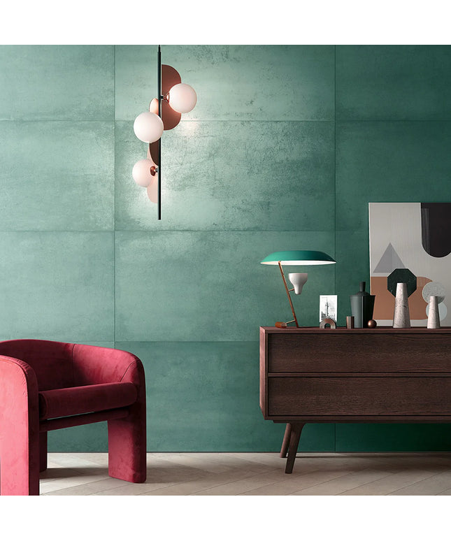 Modern interior with a green wall, red armchair, and wooden sideboard.