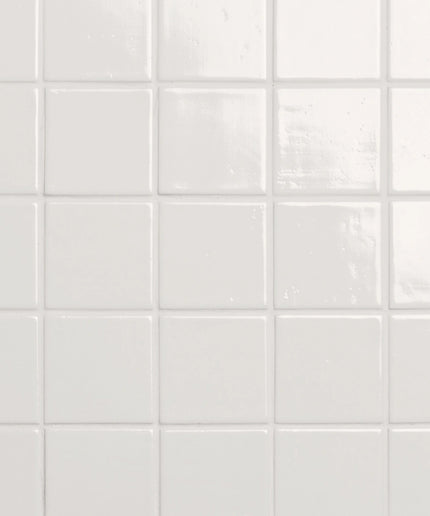 Close-up of white square tiles with a subtle pattern