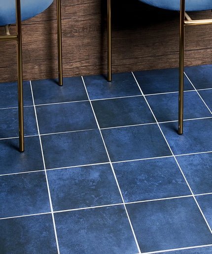 Blue tiled floor with wooden furniture legs visible