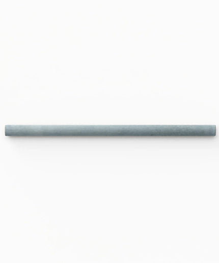 A single long, slim cylindrical product in a muted blue-gray color, positioned horizontally against a solid white background.