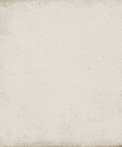 A square textured tile or backdrop with a distressed, vintage-style finish. The surface has a warm off-white, cream base with subtle speckling and darker brownish-gray weathered edges.