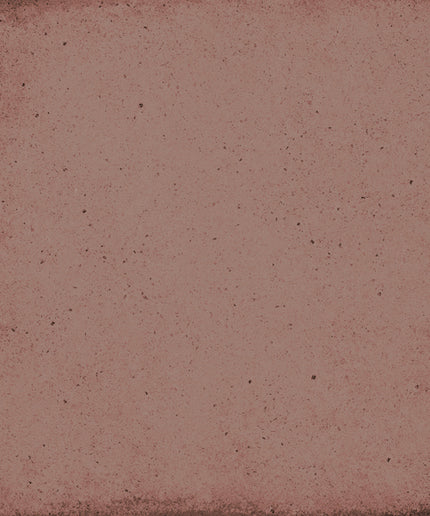 A square textured tile or swatch in a dusty rose pink color with dark speckles and a distressed, vintage-style border.