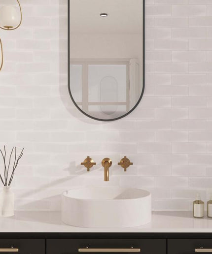 Modern bathroom with a sink, mirror, and decorative elements.