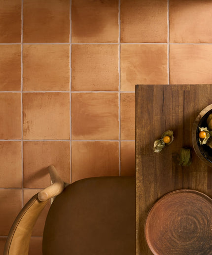 Canyon terracotta 9x9 floor tiles with warm earthy tones under dining table